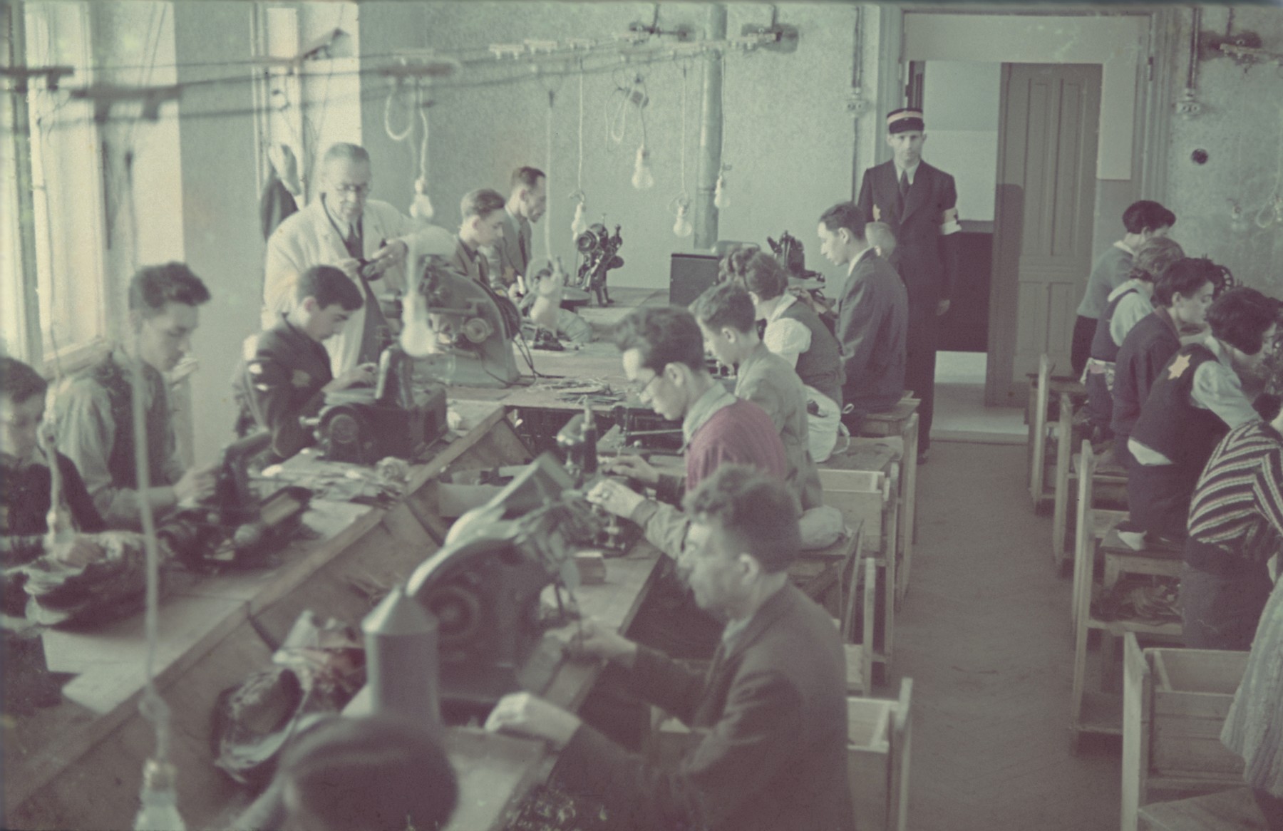 Workers in the saddle-making workshop in the Lodz ghetto.

Original German caption: "Litzmannstadt-Getto, Sattlerei" (saddlery).