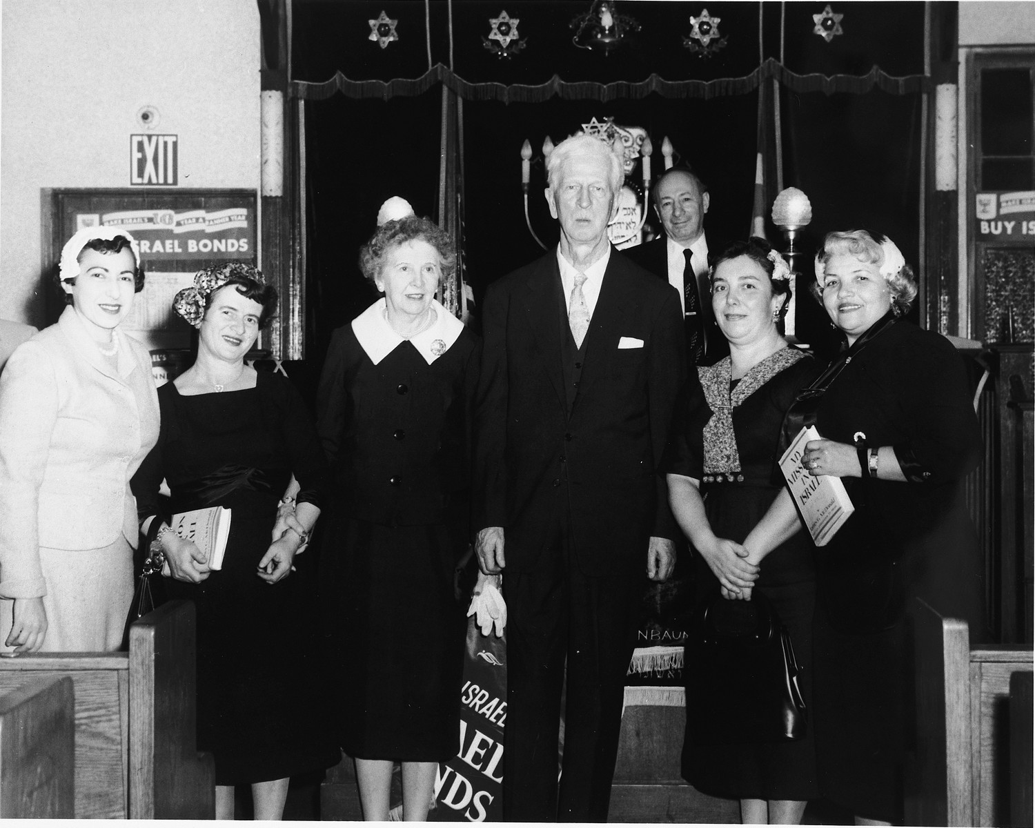 U.S. Ambassador to Israel James G. McDonald (center) poses with his wife (third from the left) and four other women at a State of Israel bonds drive at a synagogue in the U.S.

Two of the women hold copies of McDonald's 1951 memoir, "My Mission to Israel."