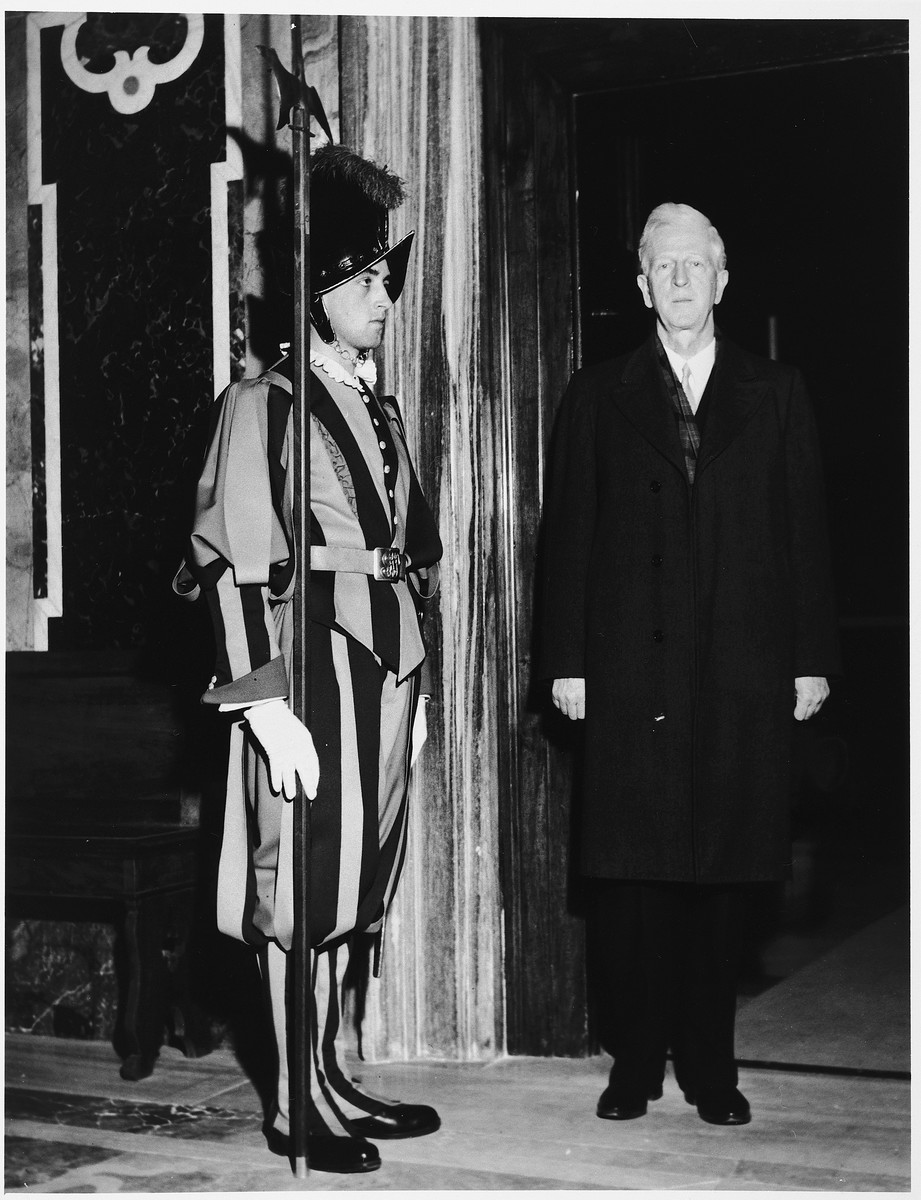 James G. McDonald, League of Nations High Commissioner for Refugees, poses next to a Swiss guard during his visit to the Vatican for an audience with Eugenio Cardinal Pacelli (later Pope Pius XII).