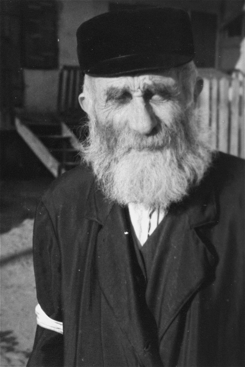Portrait of an elderly religious Jew wearing an armband in an unidentified ghetto.