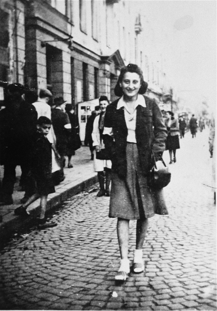 Sylvia Kramarski Kolski, on the streets of the Warsaw ghetto. 

She was 21 years old at the time. Mrs. Kolski kept all of her pre-war and wartime photos in a cloth pouch around her neck after her mother appeared to her in a dream telling her to do so. She was thus able to preserve them throughout the two year period she was in hiding.
