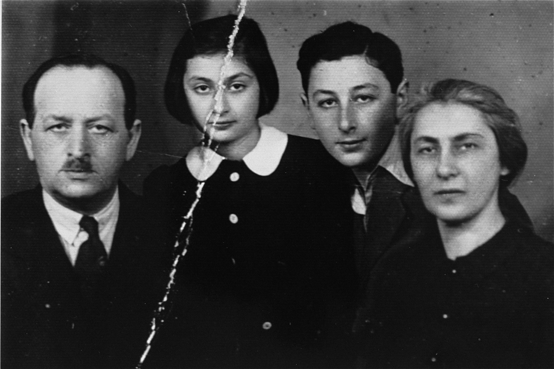 Passport photo of the Rozenman family, prepared in the Warsaw ghetto for a possiblity of an escape.  

Pictured from right to left: Regina Renia, the donor's mother; Ryszard, donor's brother; Bianka, the donor and Pawel Rozenman, donor's father.  Bianka is the only survivor.