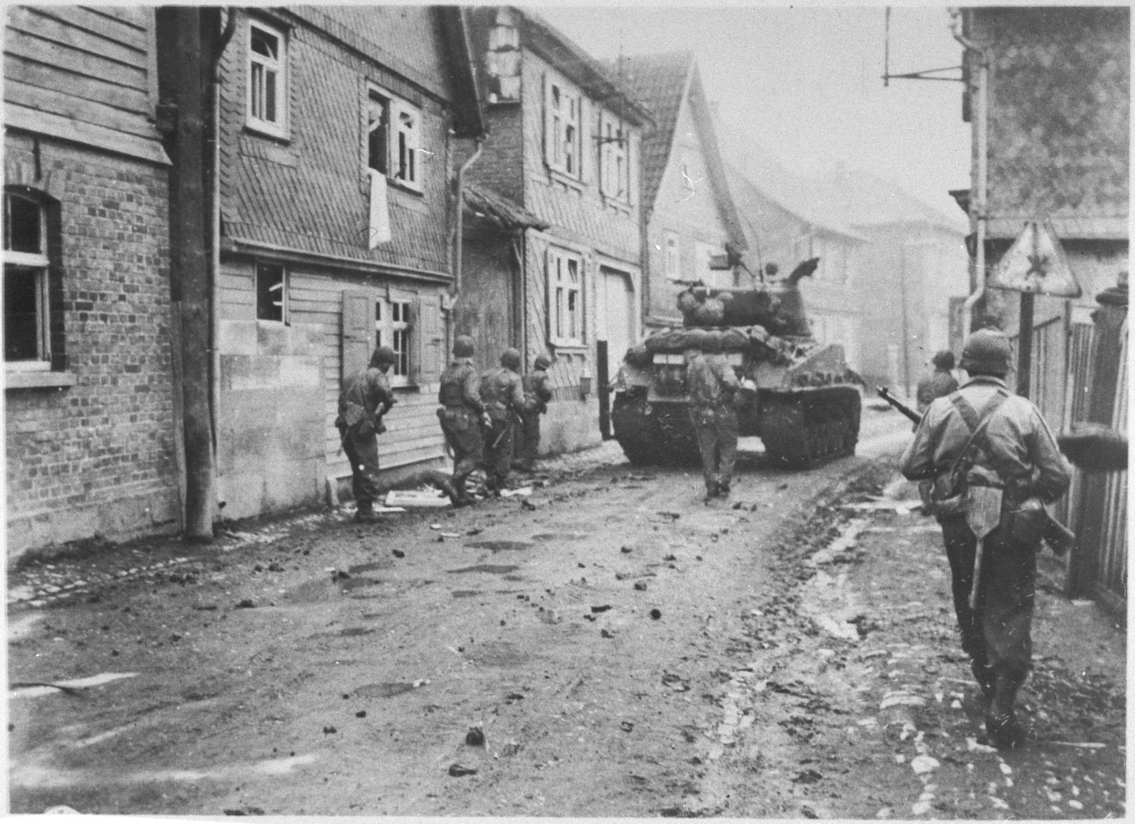 American troops advance through the streets of Aachen during the liberation of Germany.