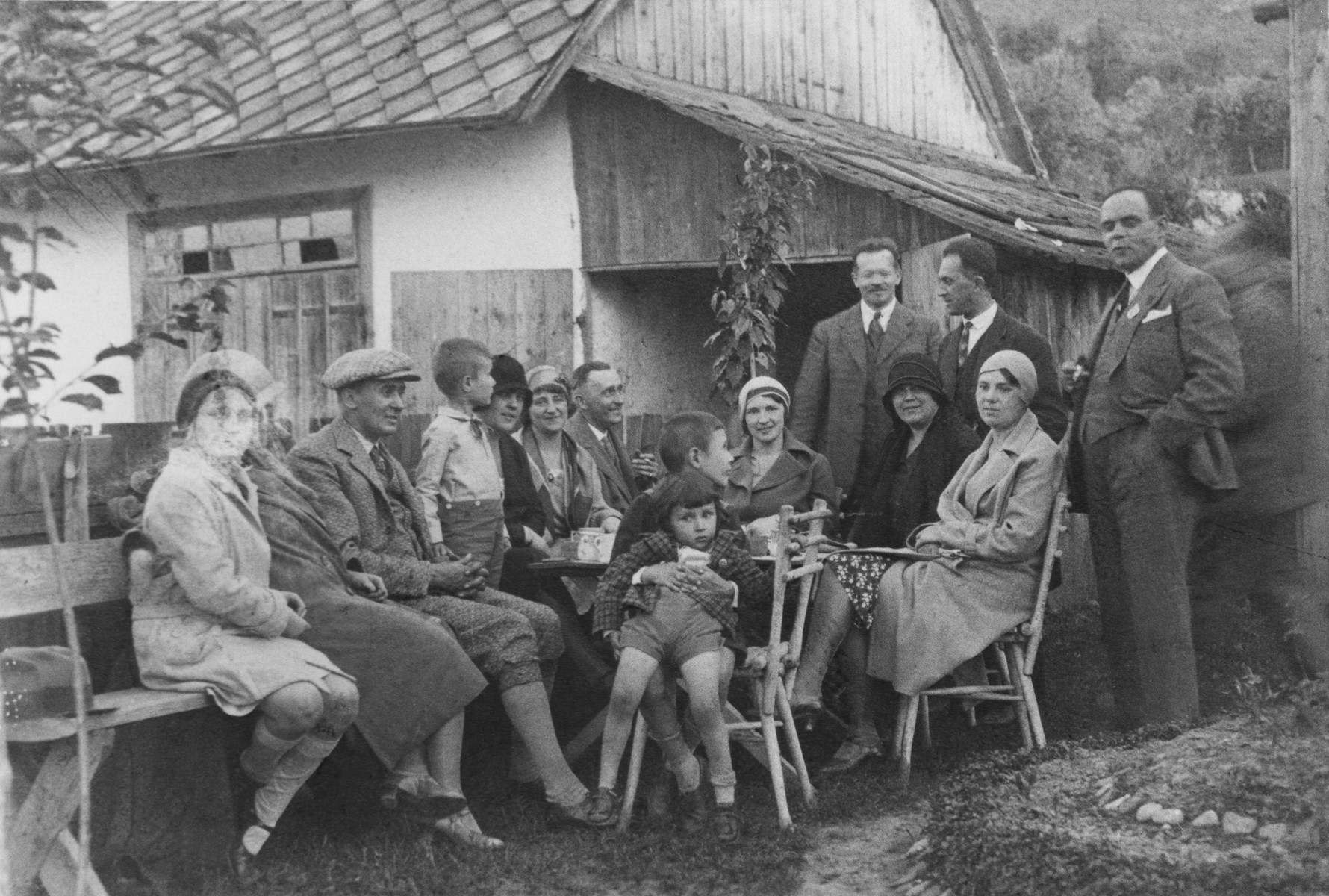 Lotte Gottfried (left) attends a social gathering at the home of the Offners, a Romanian family in Czernowitz.  

She was escorted to the party by a family friend, Dr. Brilliant (standing third from the right).  Brilliant became a Nazi supporter after a trip to Berlin in 1938 and abruptly terminated his long standing friendship with the Gottfrieds.