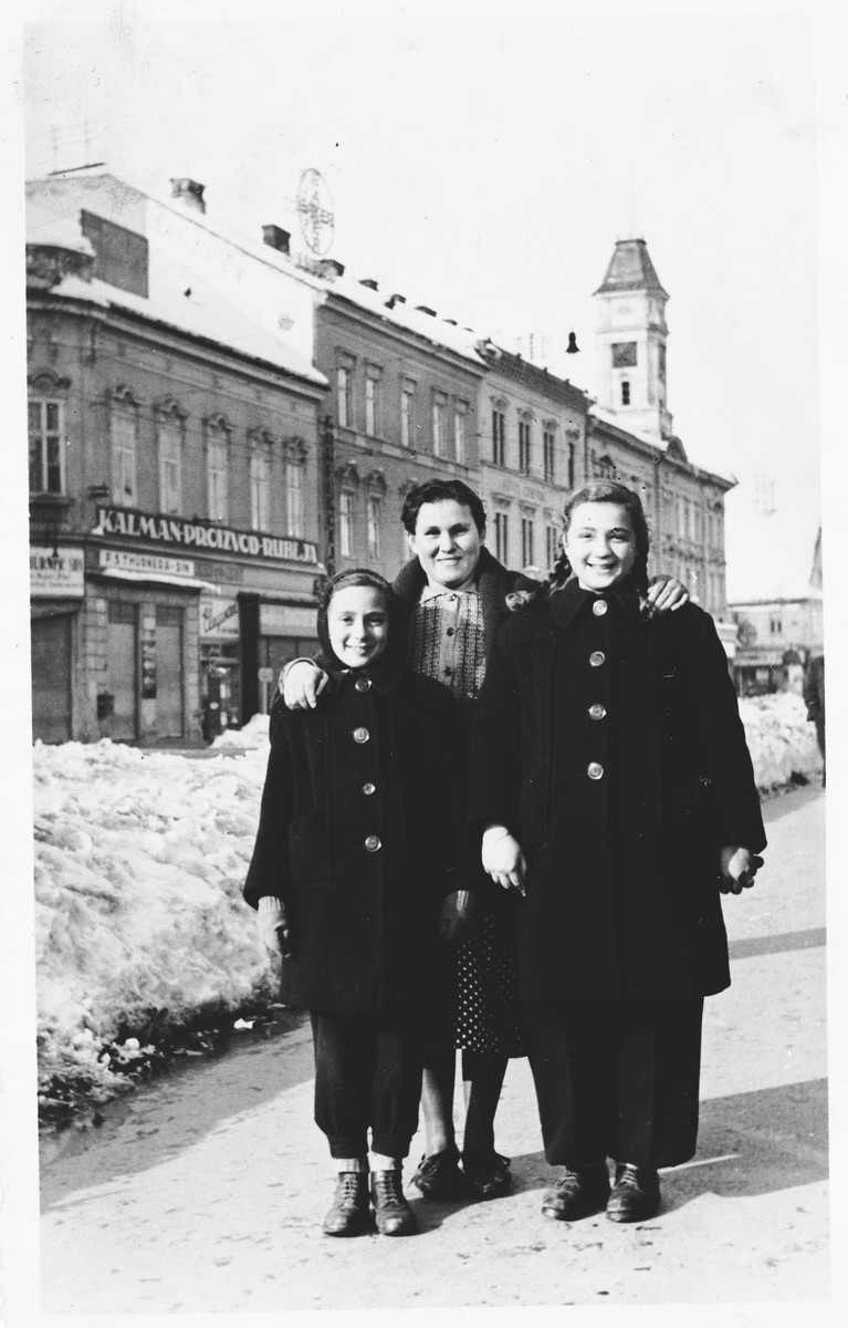 Two Jewish sisters pose with their nanny on a street in Osijek, Croatia.

Pictured in front are Miriam Spitzer (right) and Leah Spitzer (left).