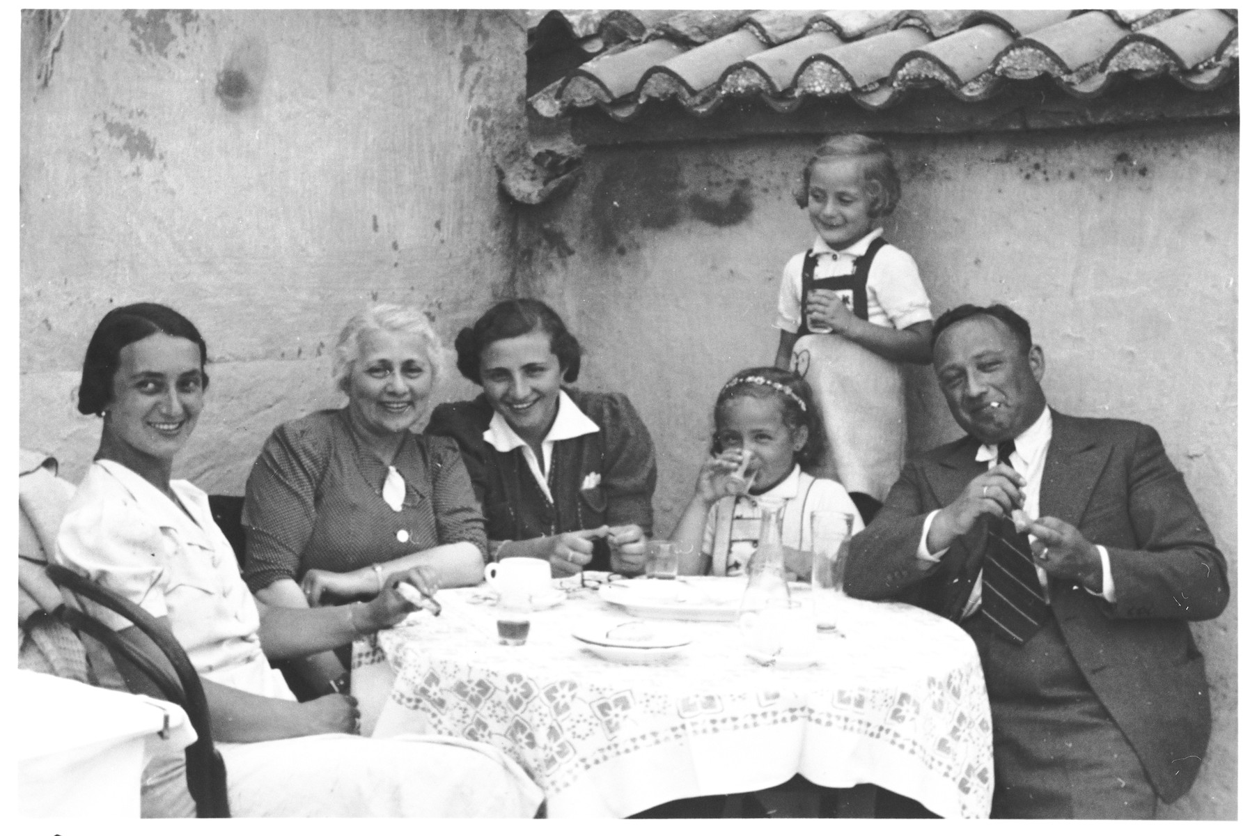 Members of the Spitzer family sit outside around a table.