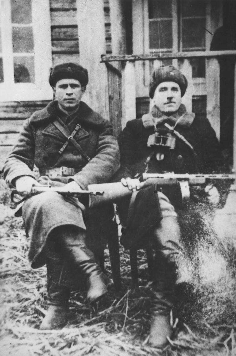 Two commissars of the Molotov partisan brigade pose outside with their rifles.

Pictured on the left is Vasiliy Timofeevich Merkul, commissar of the 101th Aleksandr Nevskiy partisan brigade.  On the right is Ivan Yevmenovich Zhenov, commissar of the Shish partisan detachment.
