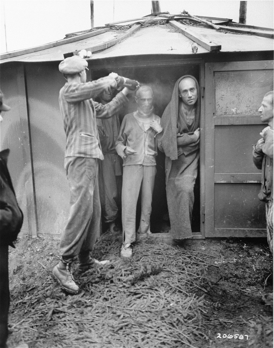 Survivors in the Ampfing concentration camp are deloused after the liberation of the camp by men of the 14th Armored Division, 3rd US army.