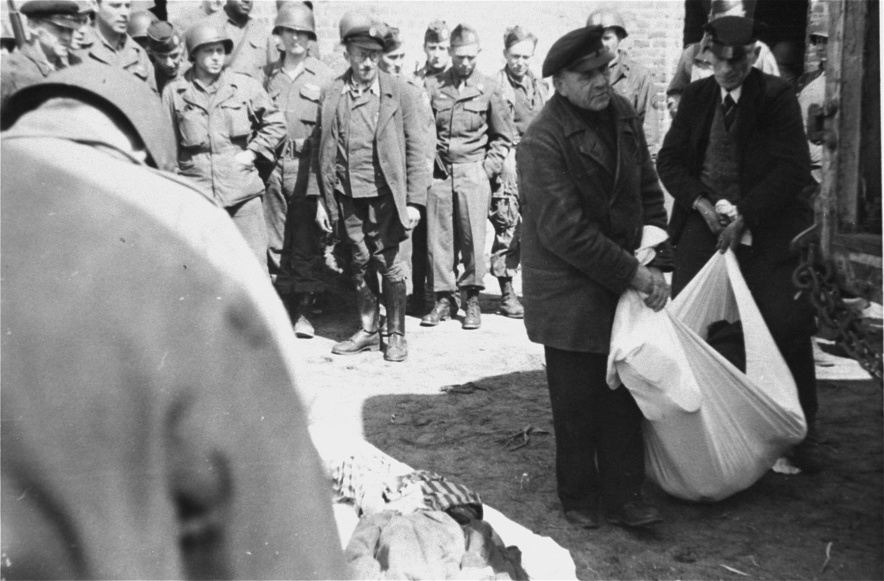 German civilians from the nearby town of Ludwigslust are made to clear corpses from barracks of the Woebbelin concentration camp.