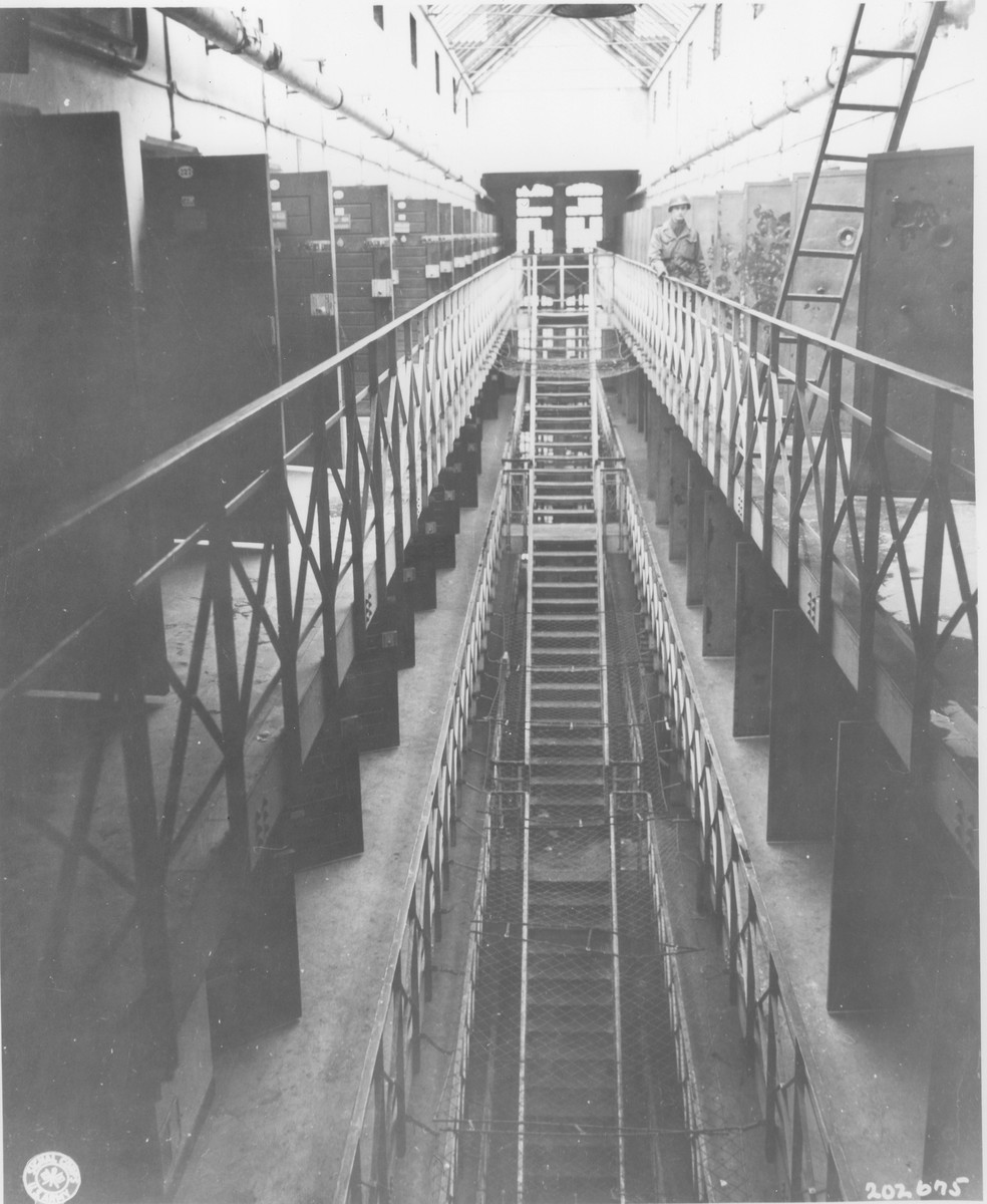 The interior of the Gestapo prison in Koeln.  

Prisoners were forced to run these stairs while they were whipped by guards.  Prisoners supposedly stripped the paint from the doors next to which the American officer is standing as a result of going mad from Allied air raids.