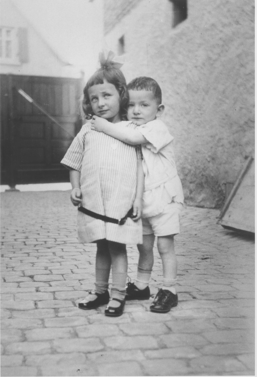 Two young Jewish siblings pose in the courtyard of their home in Guntersblum, Germany.

Pictured are Gretel and Otto Lichtenstein, cousins of the Rueb family,