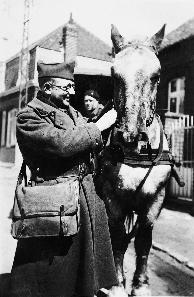 A French Jewish soldier cares for his horse.

Pictured is Andre Samuel.
