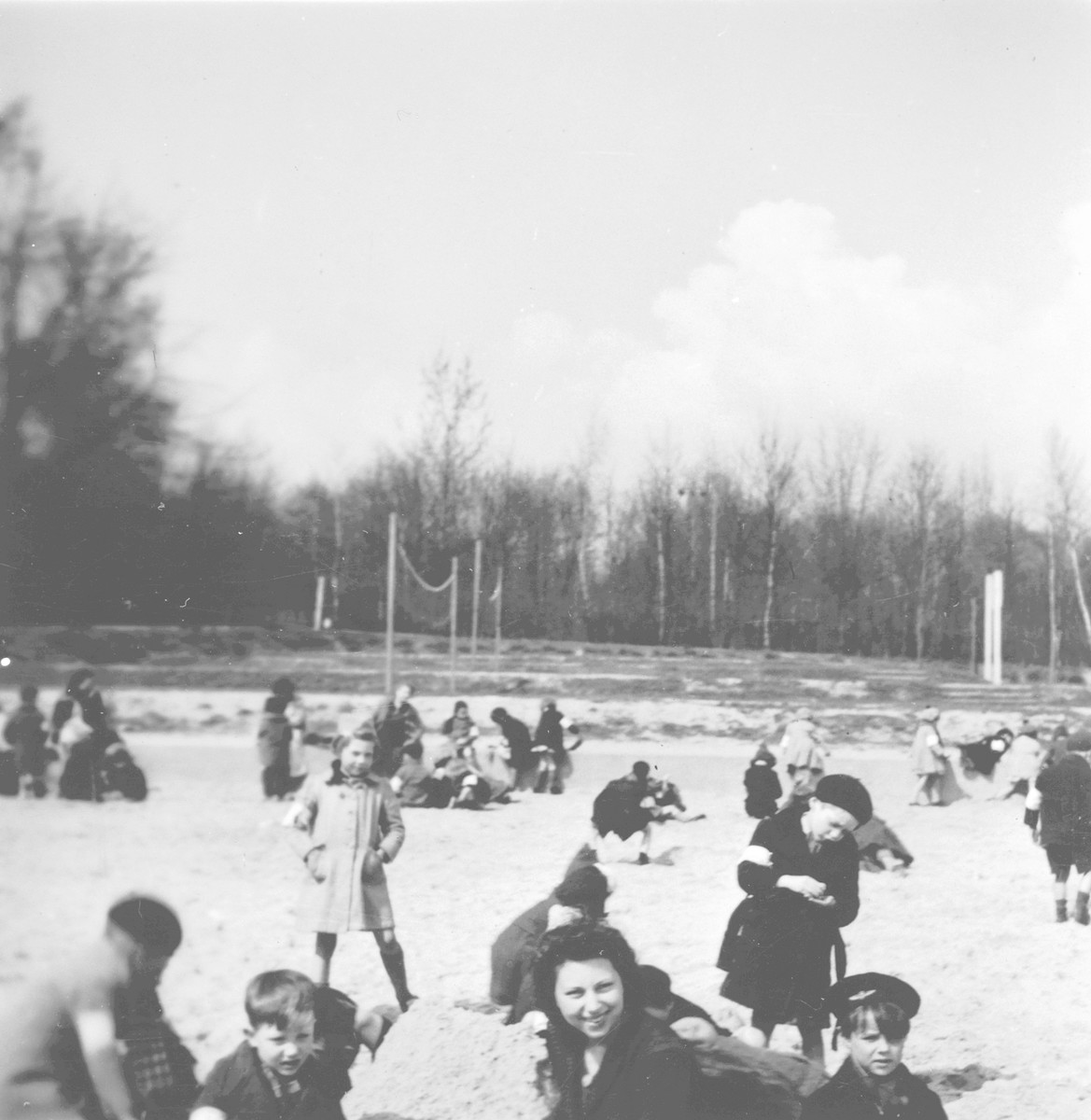 Teachers supervise children at play [probably in the Nos Petitis kindergarten.]