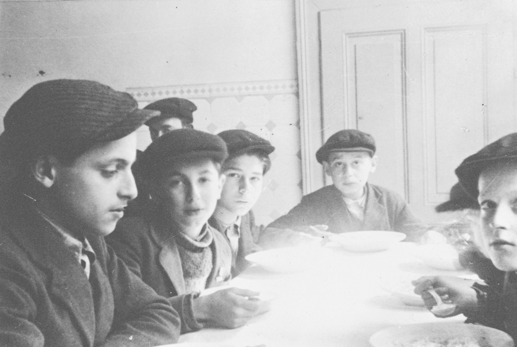 Boys and teenagers eat a meal in Bad Nauheim, a children's home run by the Vaad Hatzala.