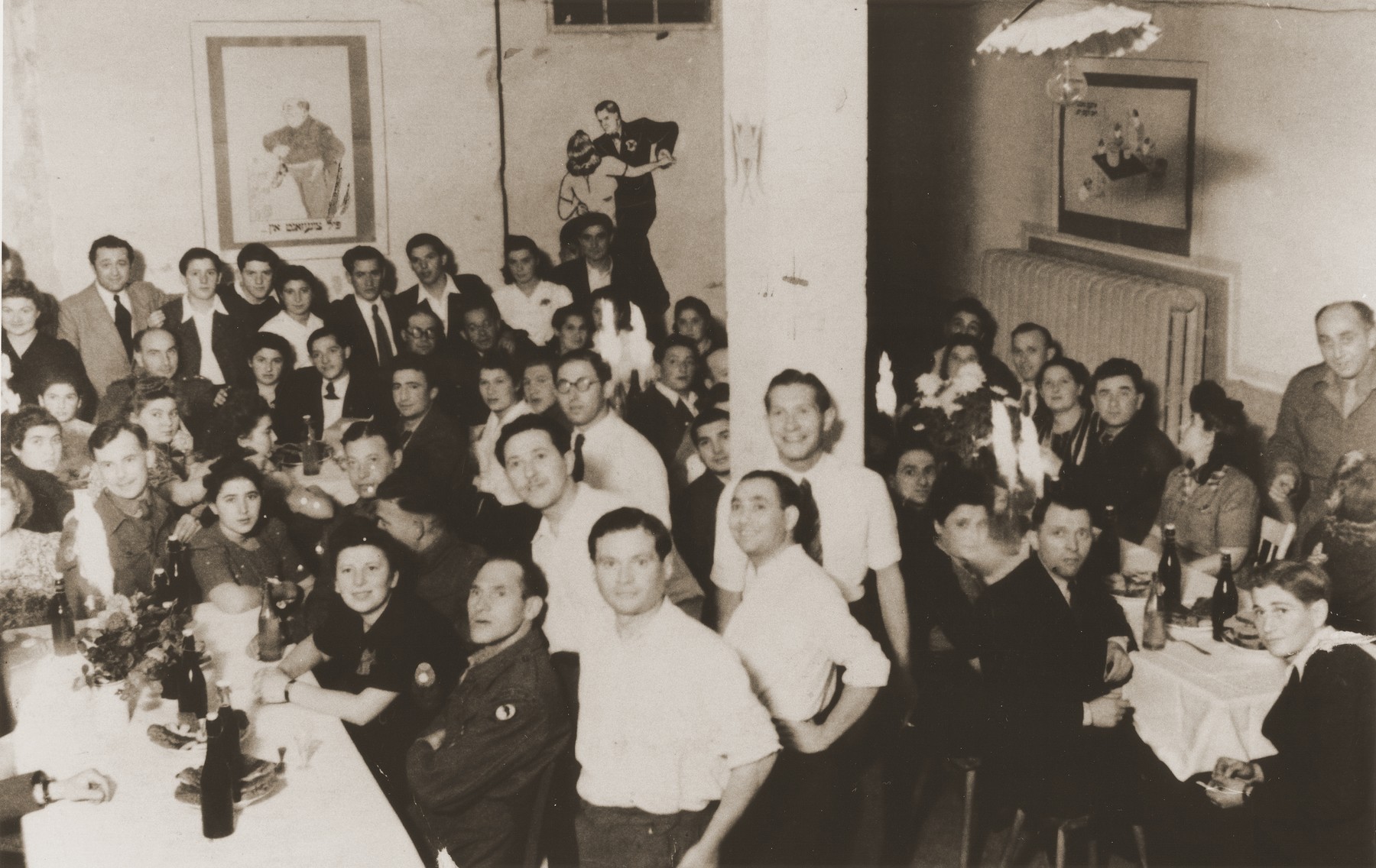 Jewish residents and British soldiers attend a party in the Vinnhorst displaced persons center.

Included in the photo are Manek Lipke. Halinka Lipke, Nadia, Tola Pilcewicz, Herman Zelman, Chaska Lipke, Monya Sender and Kapelusz. The latter was drowned in a lake after being forcibly held underwater by antisemtiic German boys.