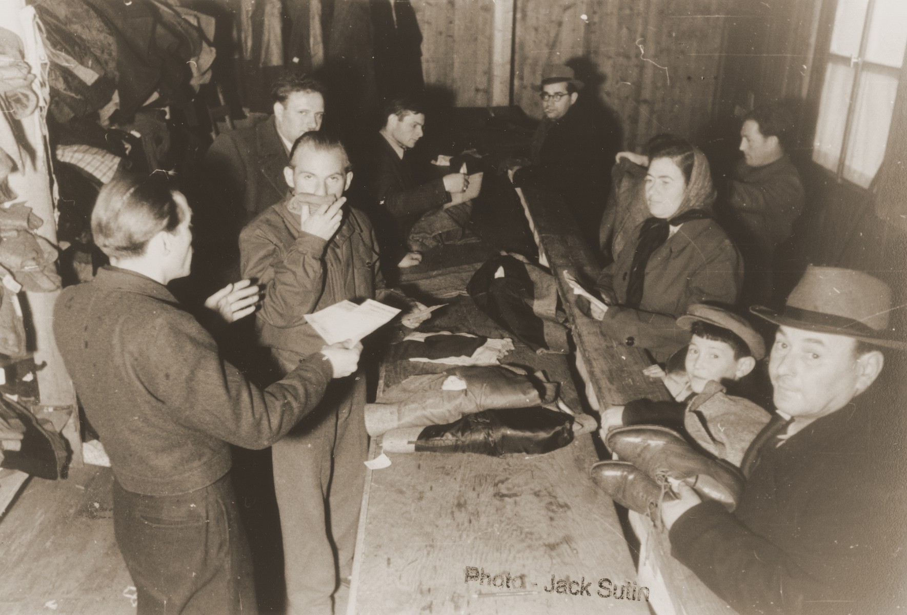 Clothing distribution center in the Neu Freimann displaced persons camp.  

Camp administrator, Izik Sutin, stands third from the left.