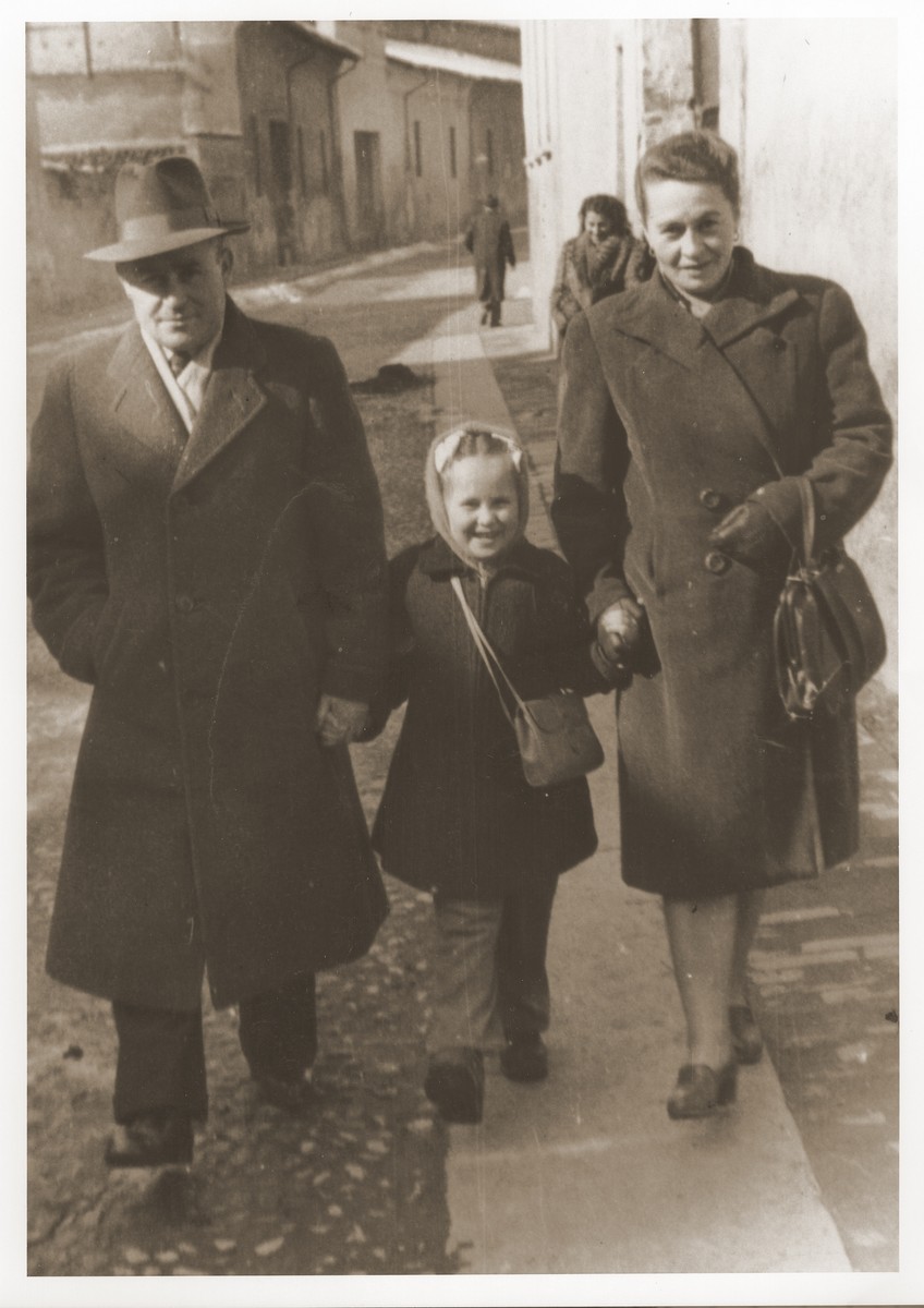 A Jewish DP family walks along a street in Cremona.

Pictured are Motel, Zelda and Masha Leikach.