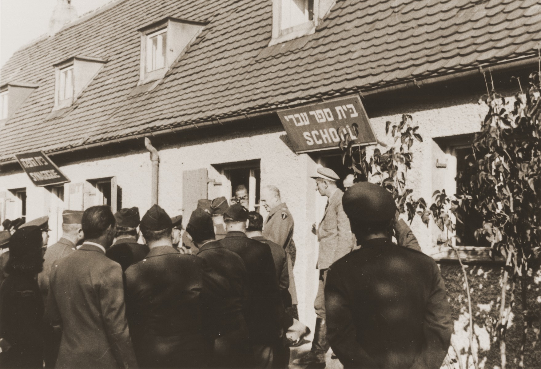 General Dwight Eisenhower visits the school and synagogue during an official tour of the Neu Freimann displaced persons camp.