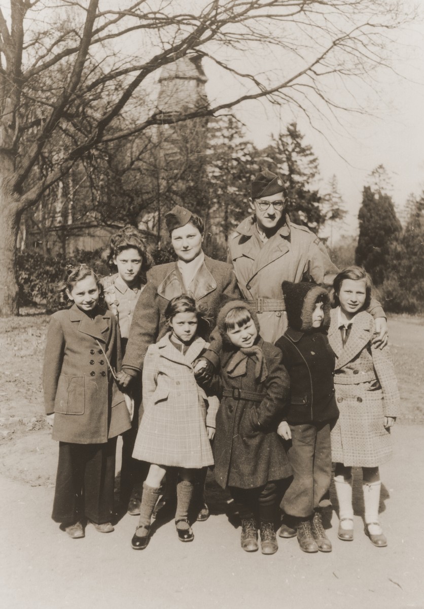 Selma Bendremer and Mr. Francel, an UNRRA representative from the United States, wait with a group of orphans for the buses that will take them to Hanover, where they will catch a train to Marseille. The second boy from the right is Peter Salomon (Peter Ruben Lewkowitz) now known as Yiphtach Ronen.