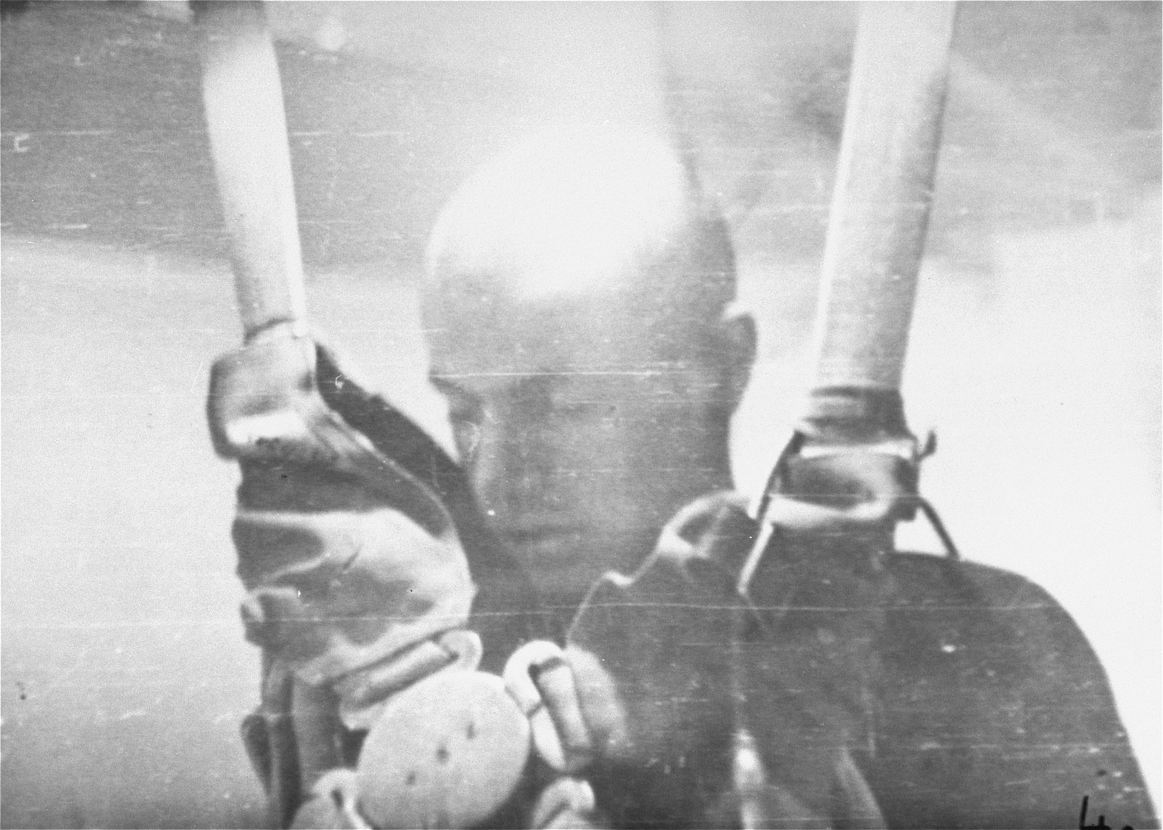 A prisoner in a special chamber falls into unconsciousness after being subjected to low pressure experimentation.  For the benefit of the Luftwaffe, air pressures were created comparable to those found at 15,000 meters in altitute, in an effort to determine how high German pilots could fly and survive.