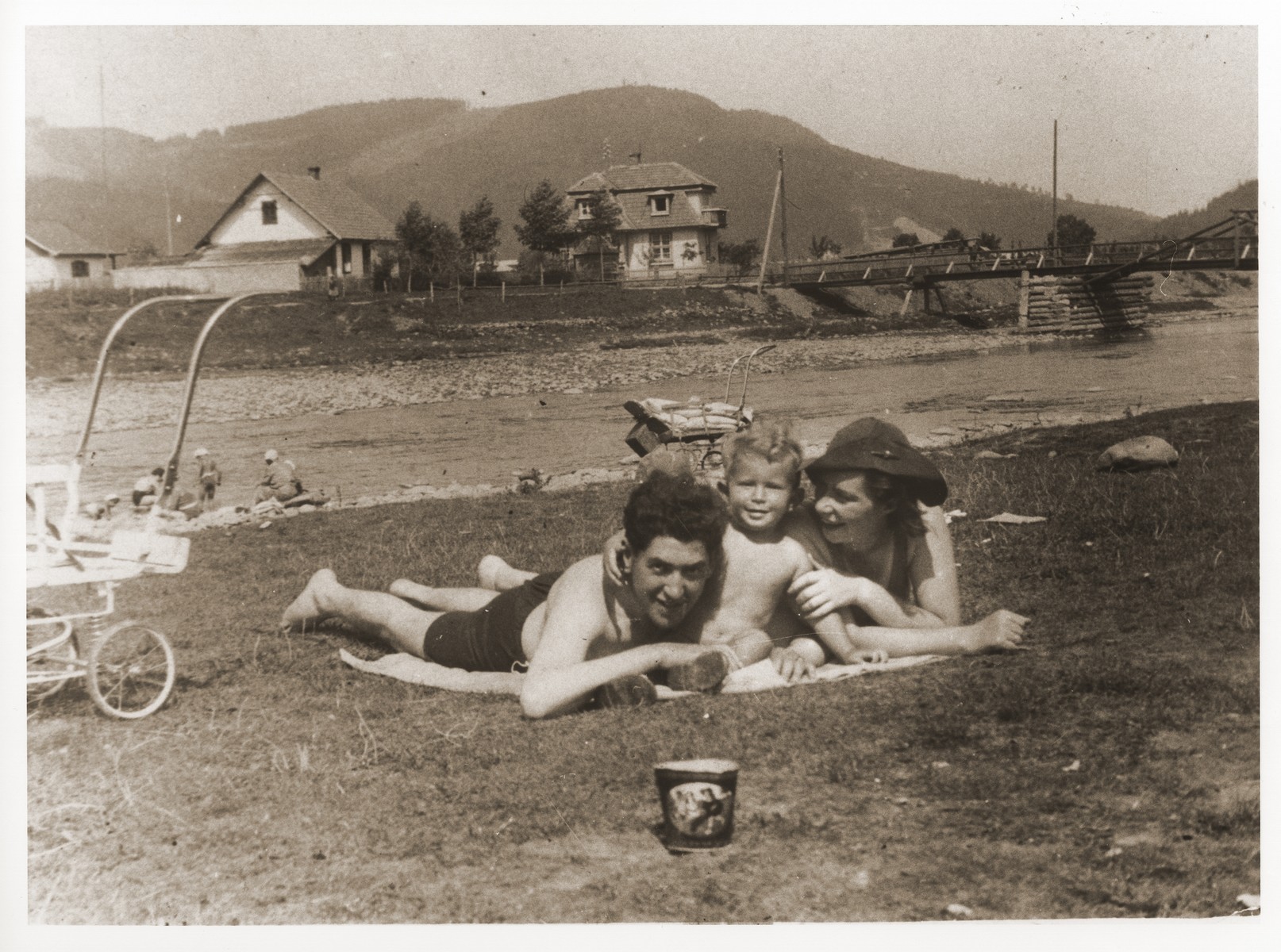 A Jewish couple sunbathes with their son on the beach in the resort town of Skole, shortly before the German invasion of Poland.

Pictured are Izio and Anda Littman with their son, Otto.