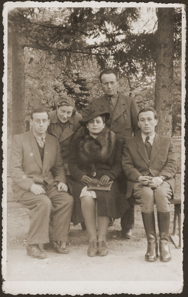 Group portrait of Jewish survivors in Bedzin, Poland.  

Seated in the front row, from left are: Majer Fiszel; Lola (Merin) Laskier, and Heniek Fiszel.  The other two are not identified.