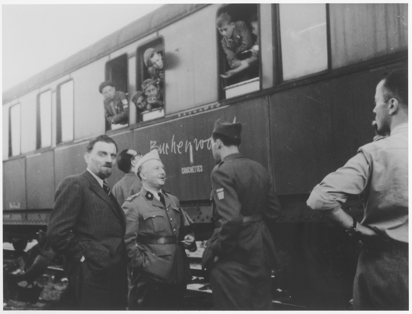 OSE official, Joseph Weill (left), and Dr. G. Revel (center) greet the Buchenwald children's transport upon its arrival in the Les Andelys train station.  From here the children will be taken to the Ecouis children's home.
