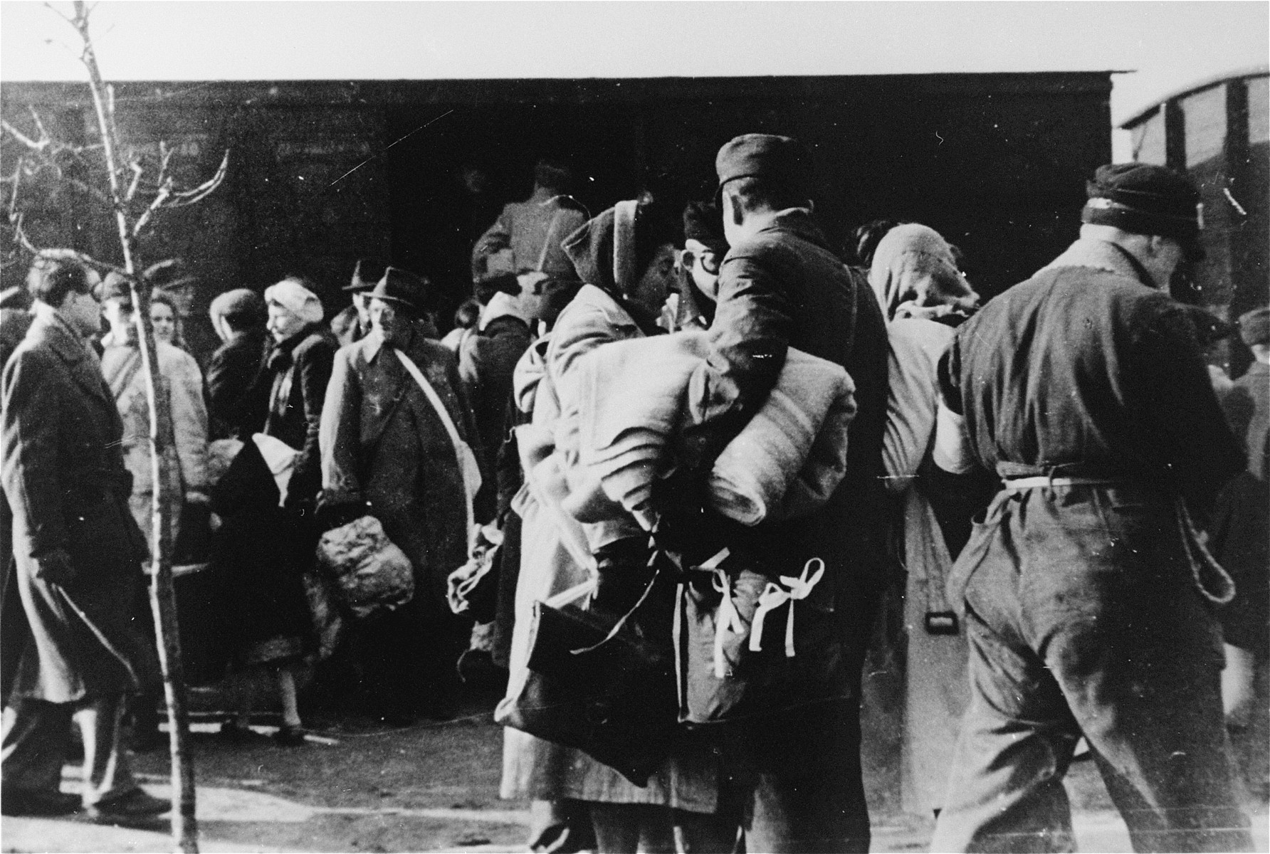 The deportation of Jews from Westerbork.  Members of the Ordedienst (Jewish police) are visible in the foreground.