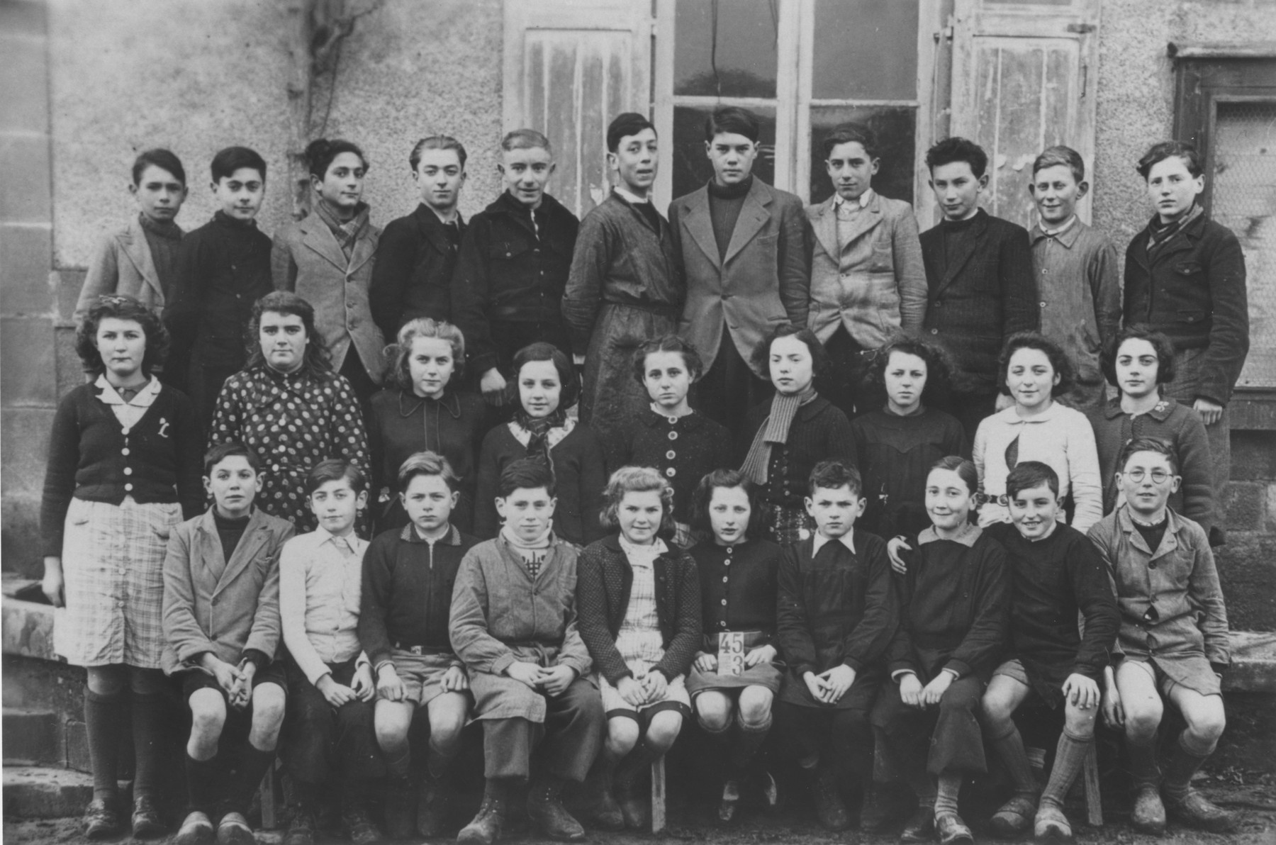 Class portrait of students at the Ecole Saint Pierre de Fursac, a school attended by Jewish refugee children living at the Chabannes children's home, as well as those from the village. 

Pictured in the front row, from left to right are: unknown; Pierre Lafaye; Jo Jacob; unknown; Renaud; Andre Dubois; unknown; Margot Weinberg; Plavinet; Andre Lelong; Kostia Sotnikov.  Second row: Paulette Leblanc; Marcelle Fedon; unknown; Grosset; Irene Clement; Jeanne Luguet; Paulette Legris; Gisele Brunetaud; Ginette Chanliat.  Third row: Mamet; Georges Loeffler; Norbert Bikales; Michel Razymovsky; Madeleine Boramier; Madeleine Basset; Anatole Zylberstein; unknown; unknown; unknown.