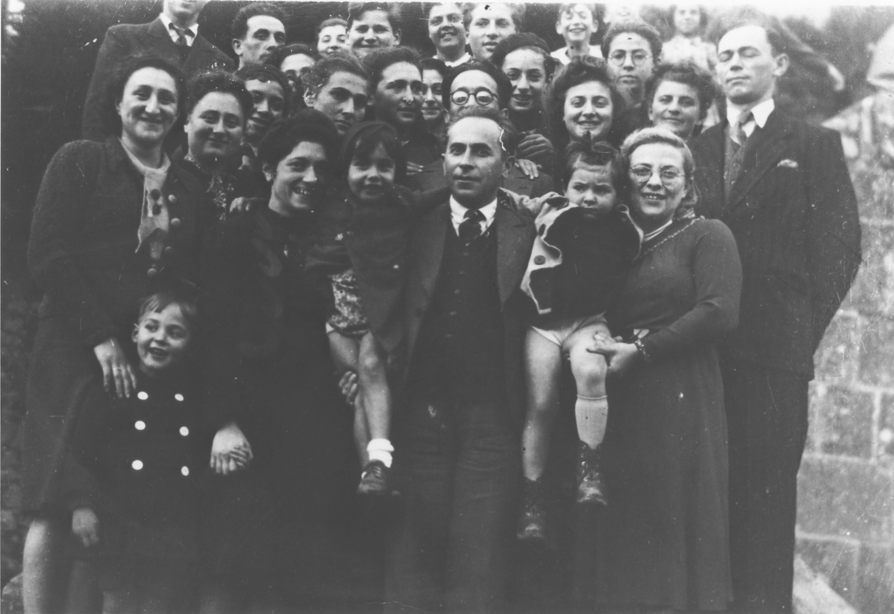 Group portrait of the children and staff of the OSE (Oeuvre de Secours aux Enfants) children's home in Masgelier.

Among those pictured are Hans Hirschberg, Dr. and Gertrude Blumenstock, Kurt Leuchter, Theo Brenig and Isidor and Louba Pudermacher, Boris, Luba and Isidor.