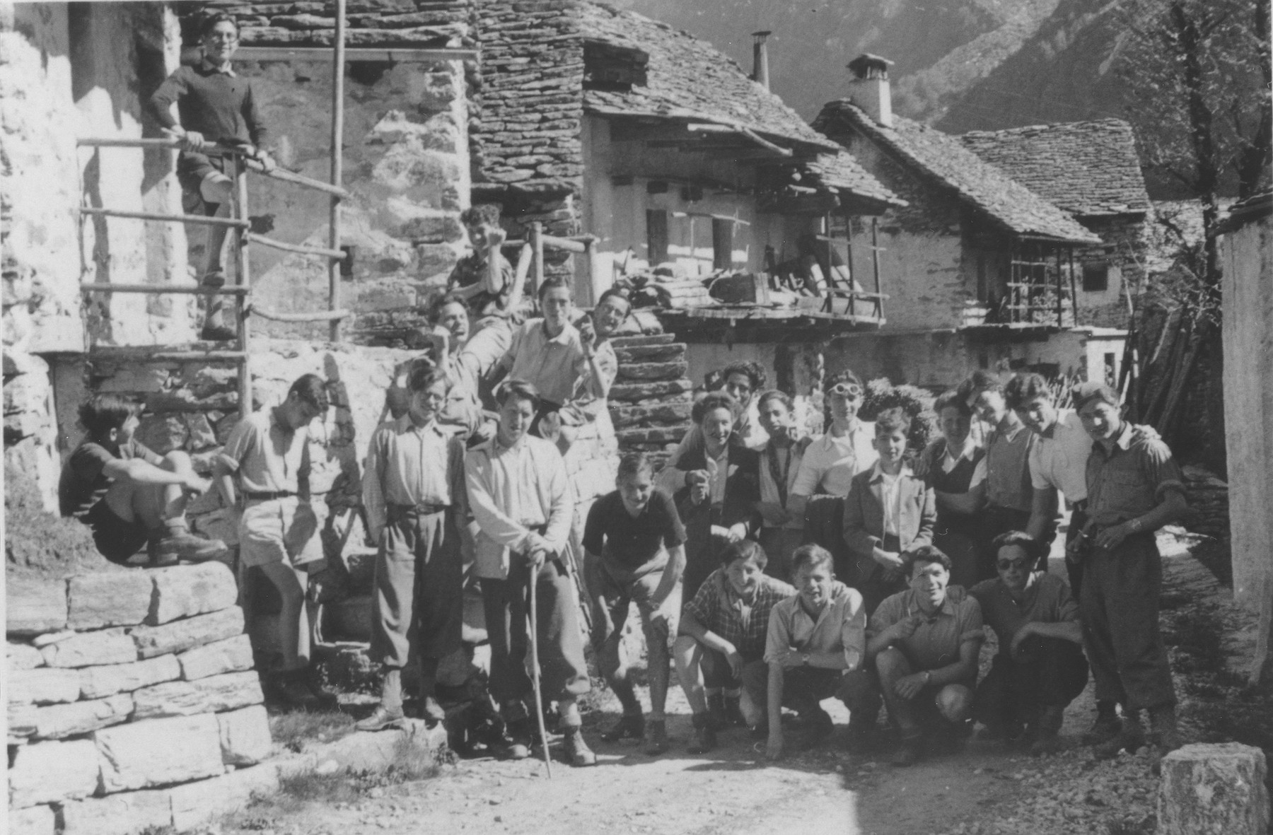 Boys from the Hôme de la Forêt children's home pose in a rustic village during a summer excursion.

Those pictured include Henri Karnowsky, his brother, Heinz Dewald, and "Jukoff".