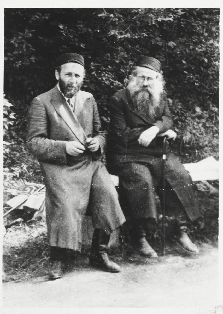 Two Hasidic men sit on a park bench in Lodz.

Tzvi Majranc is pictured on the left.