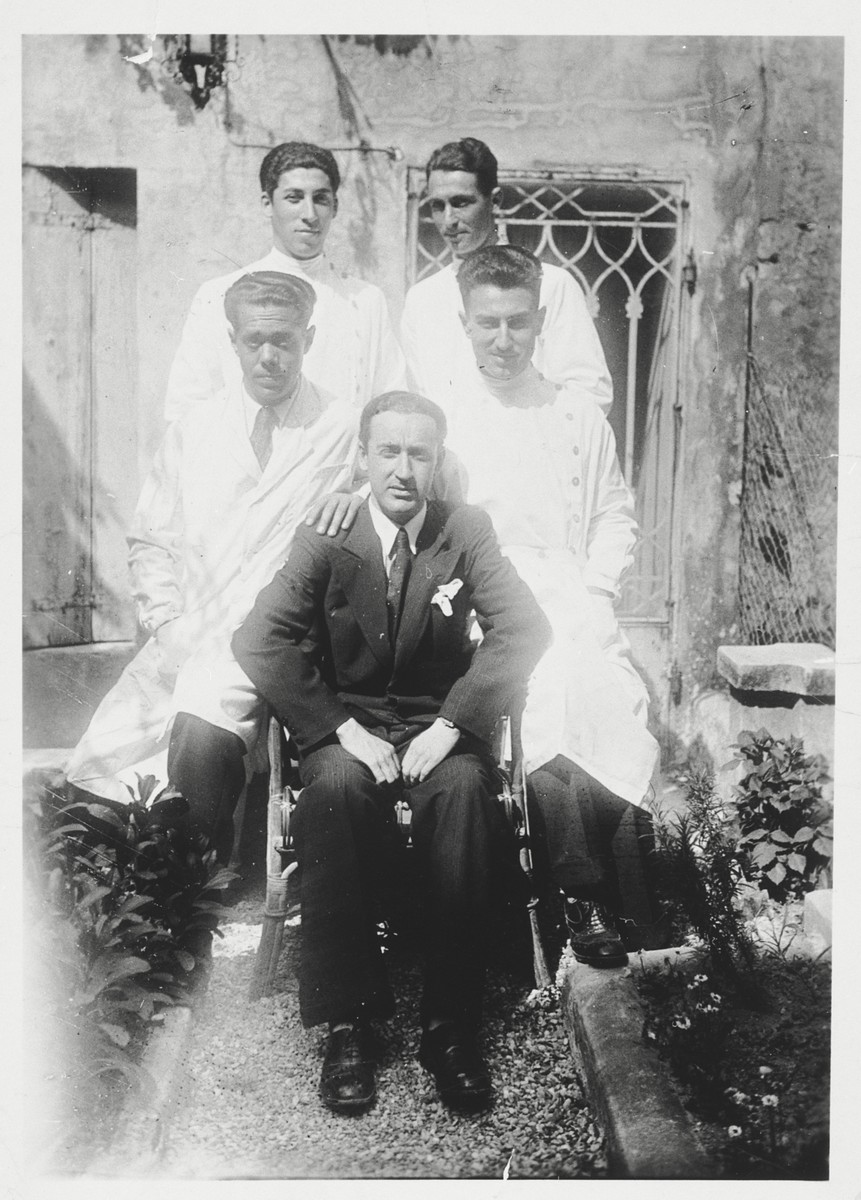 Five physicians pose in front of the hospital in Oradea.

Dr. Tibor Grunfeld is pictured at the back left.  He was later killed at Auschwitz.