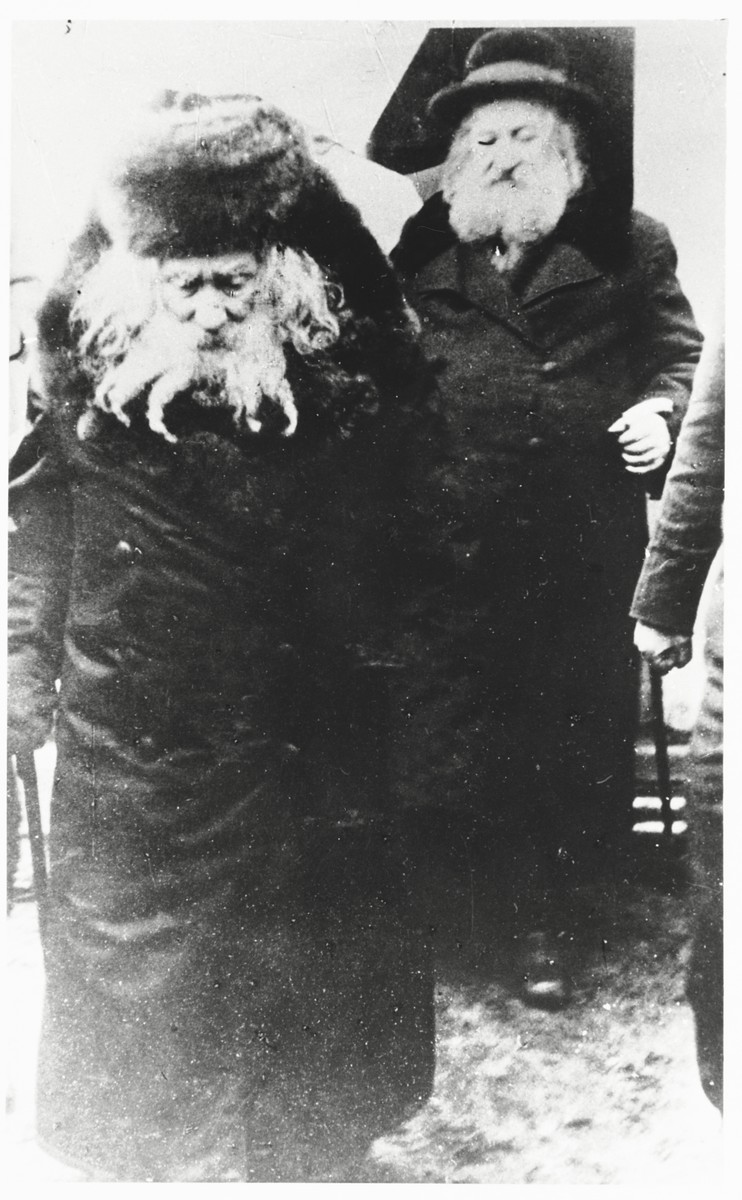 The Gerer Rebbe, Rabbi Abraham Mordecai Alter and, walks down a street accompanied by his brother Rabbi Moshe Betzelal.