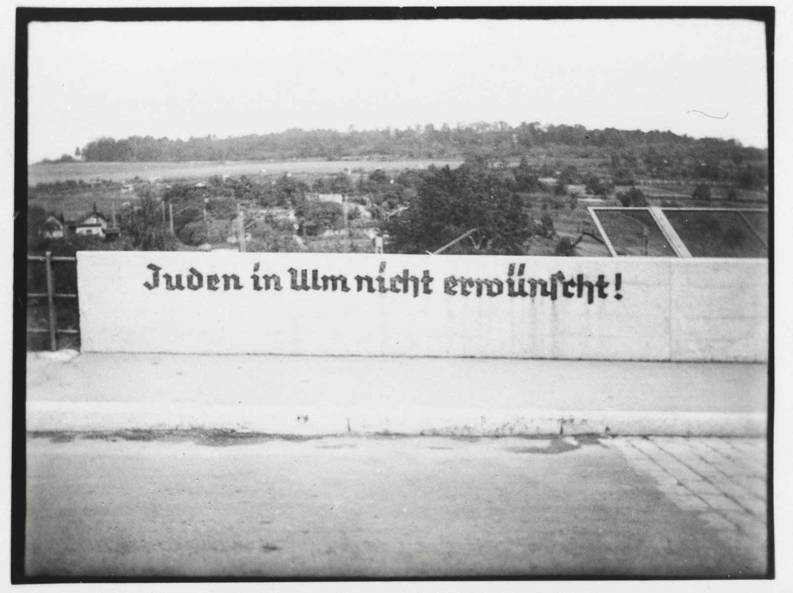 View of a sign painted on the Stuttgarter Strasse bridge in Ulm reading "Jews are not desireable in Ulm".