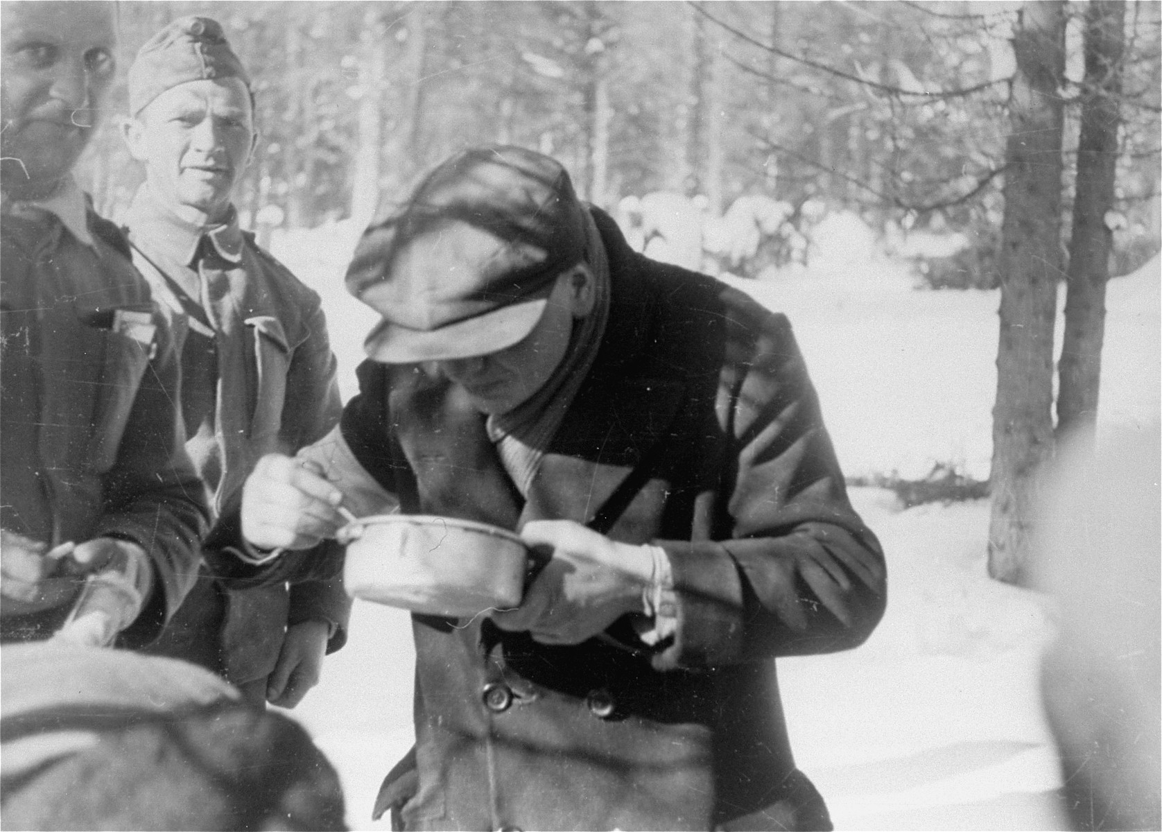 Jewish conscripts in Company 108/57 of the Hungarian Labor Service at mealtime.