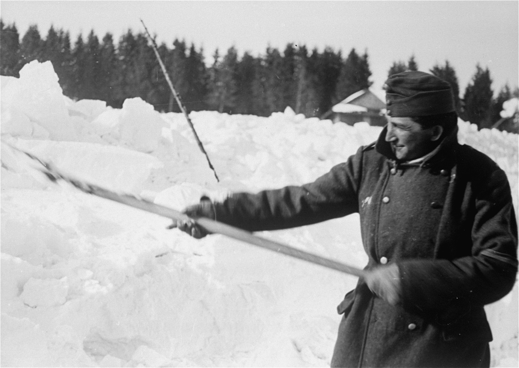 A Jewish conscript in Company 108/57 of the Hungarian Labor Service clearing snow from a road.