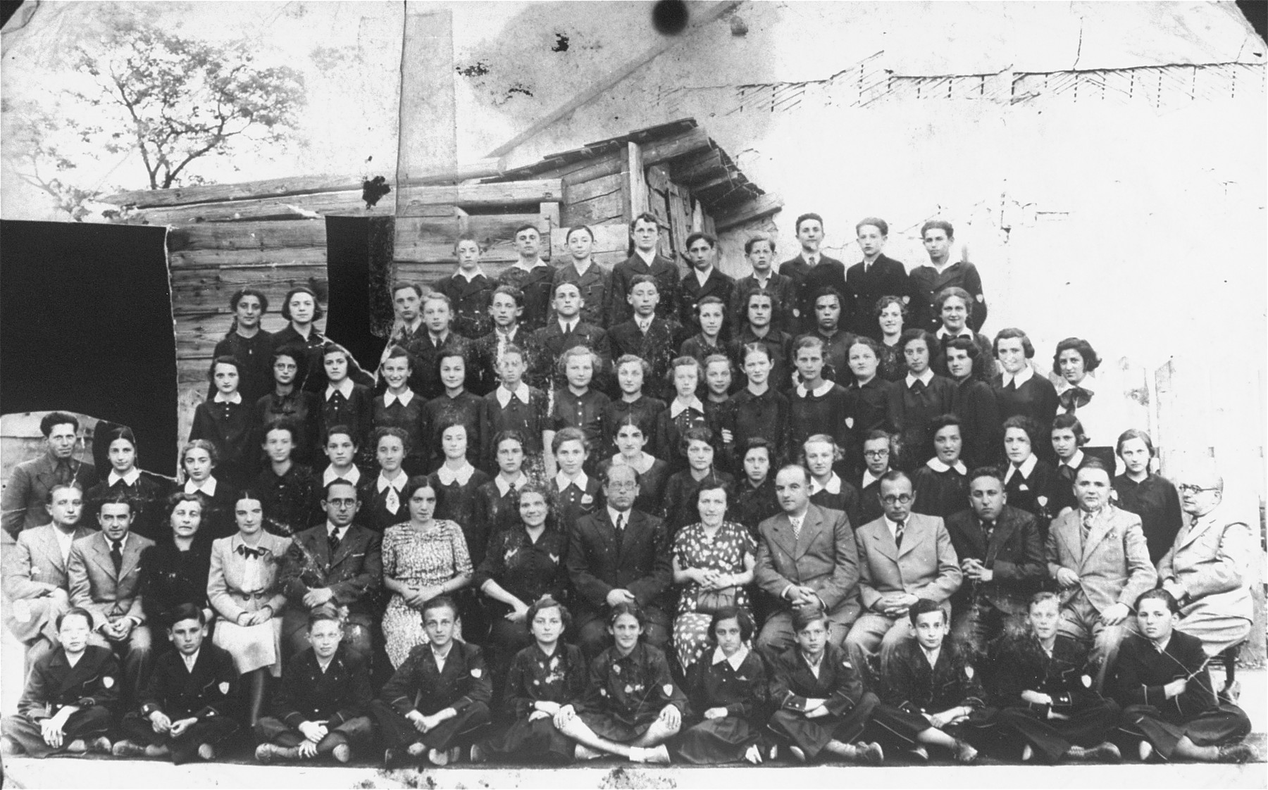 Group portrait of the faculty and students of the Hebrew gymnasium in Czortkow.

Bronia Wasserman is on the far left of the fifth row.  Her sister Zosia Wasserman is in the third row, 11th from the left.