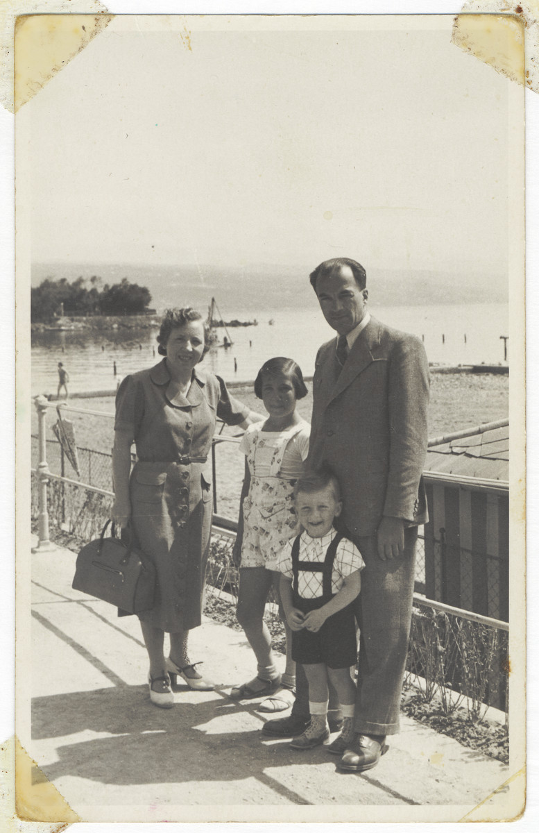 An Austrian Jewish family poses on a walkway next to the shore.

Pictured are  Sarafina and Jacob Landau, with their children Ruth and Raoul.