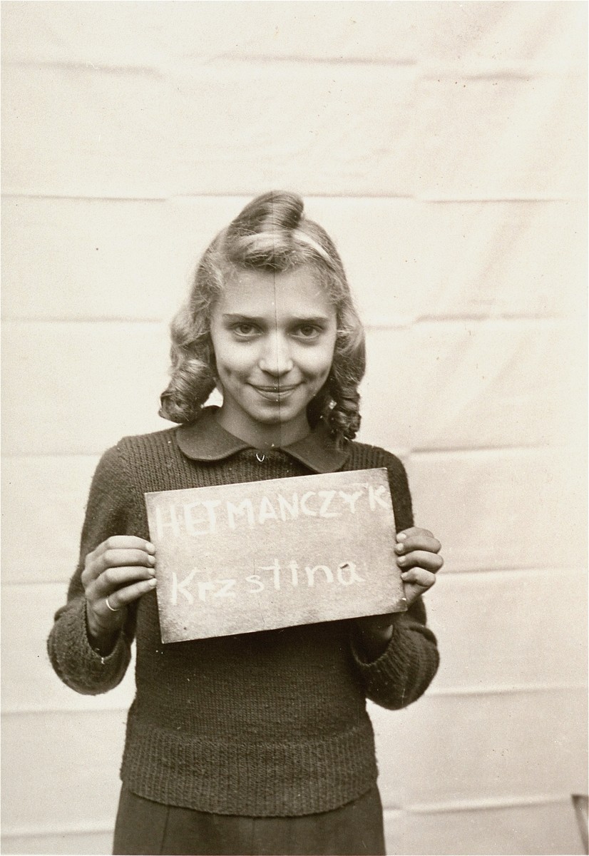 Krzstina Hetmanczyk holds a name card intended to help any of her surviving family members locate her at the Kloster Indersdorf DP camp.  This photograph was published in newspapers to facilitate reuniting the family.