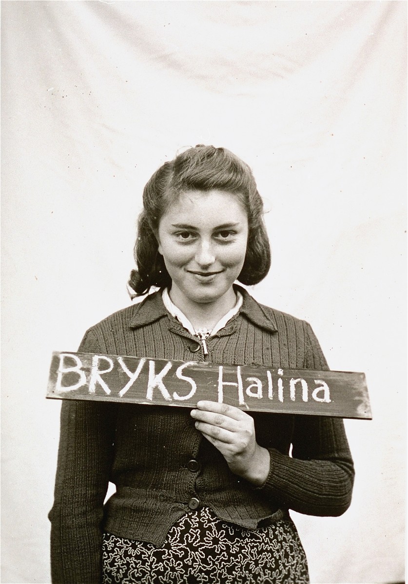 Halina Bryks holds a name card intended to help any of her surviving family members locate her at the Kloster Indersdorf DP camp.  This photograph was published in newspapers to facilitate reuniting the family.
