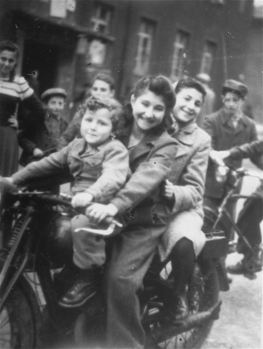 Fela Rozensztajn (on the back of the motorcycle) in a DP camp in Bad Reichenhal.