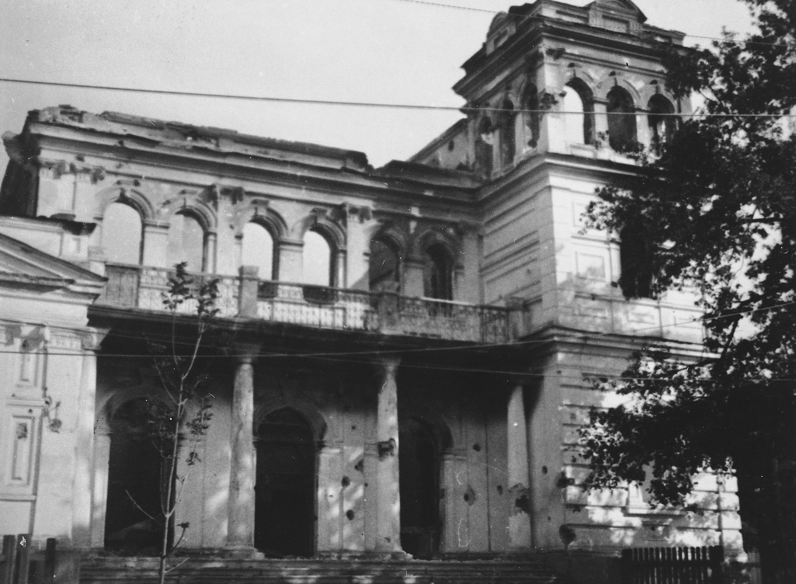 Exterior view of a large war-damaged building in the Warsaw ghetto.