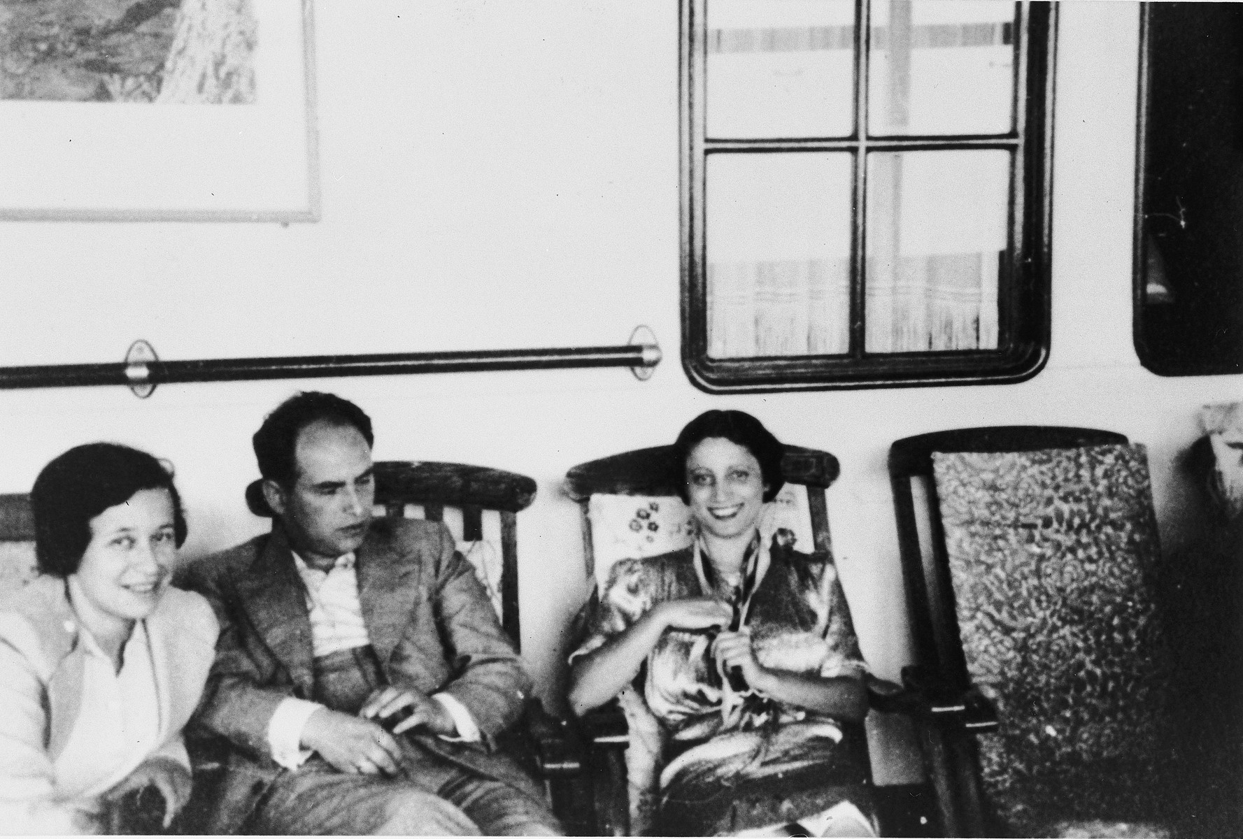 Three passengers relax on deck chairs on board the St. Louis.

From left to right are Irmgard and Josef Koeppel and Sofi Aron.