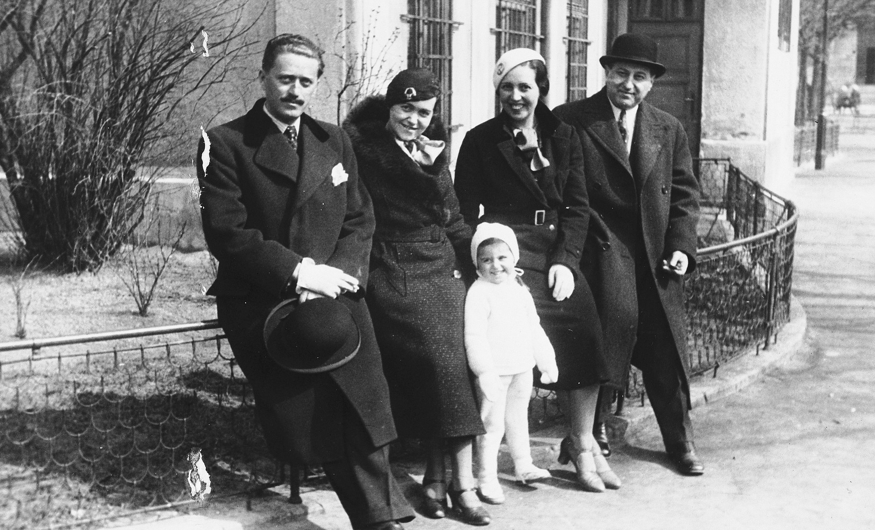 Portrait of the Weichherz family taken outside a building [probably in Bratislava].

From left to right: are Karol Ripper (a family friend in Bratislava who later died in the Holocaust), Esti Weichherz, Kitty Weichherz, Rudica Zoltan, (the wife of Bela`s brother Marcel who survived Ravensbrueck), and Bela Weichherz.

This photo was taken from the diary of Kitty's life written by her father, Bela Weichherz.