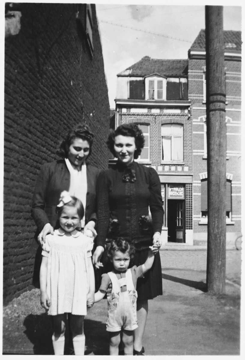 A Jewish family poses on a street in Courtrai while in hiding.

Pictured are Lea Obstfeld and her son, Norbert, her sister, Emily Zwaaf and her niece, Jacqueline.