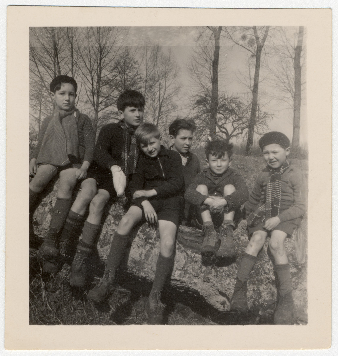 A group of Jewish children evacuated from Paris by the Quakers, outside of the Quaker boarding home, Moulin de la Ferriere, in Noce, Normandy, in early 1940. Steven Simon is the first one at left.