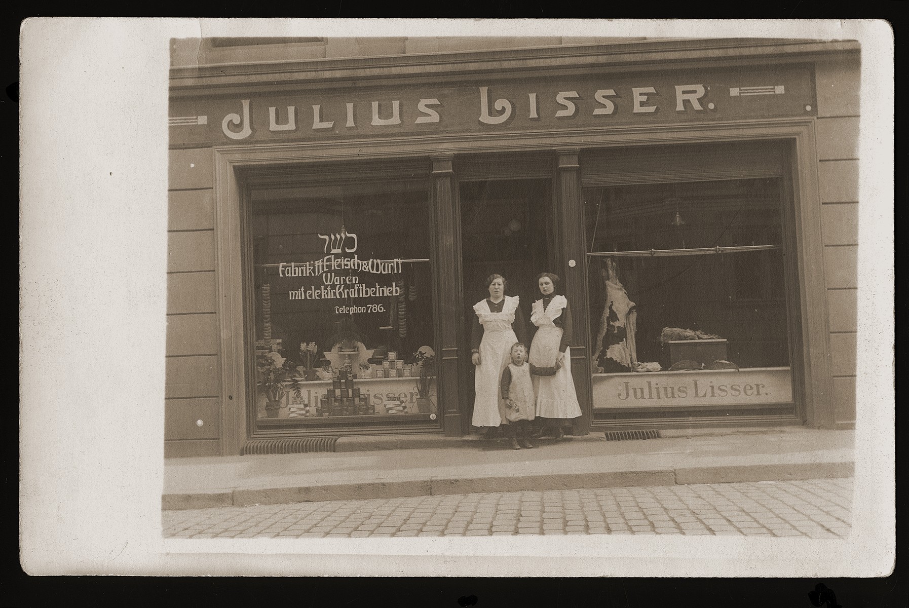 Members of the Lisser family pose in front of the Julius Lisser kosher butcher shop in Danzig.