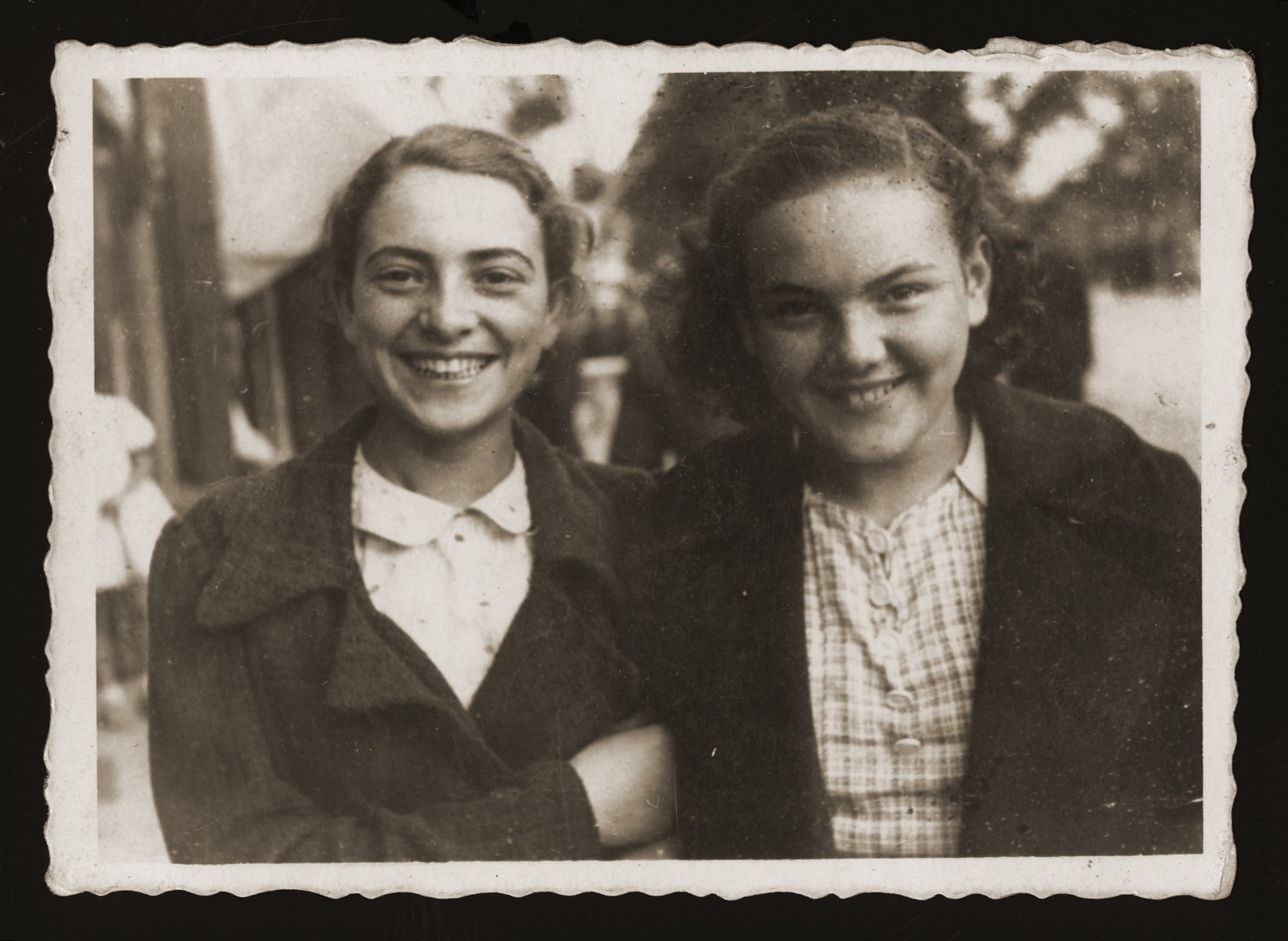 Two teenage Jewish girls pose on a street in Chelm.

Pictured are Estera Ajzen (left) and her friend, Maniusia Wajntraub (right).