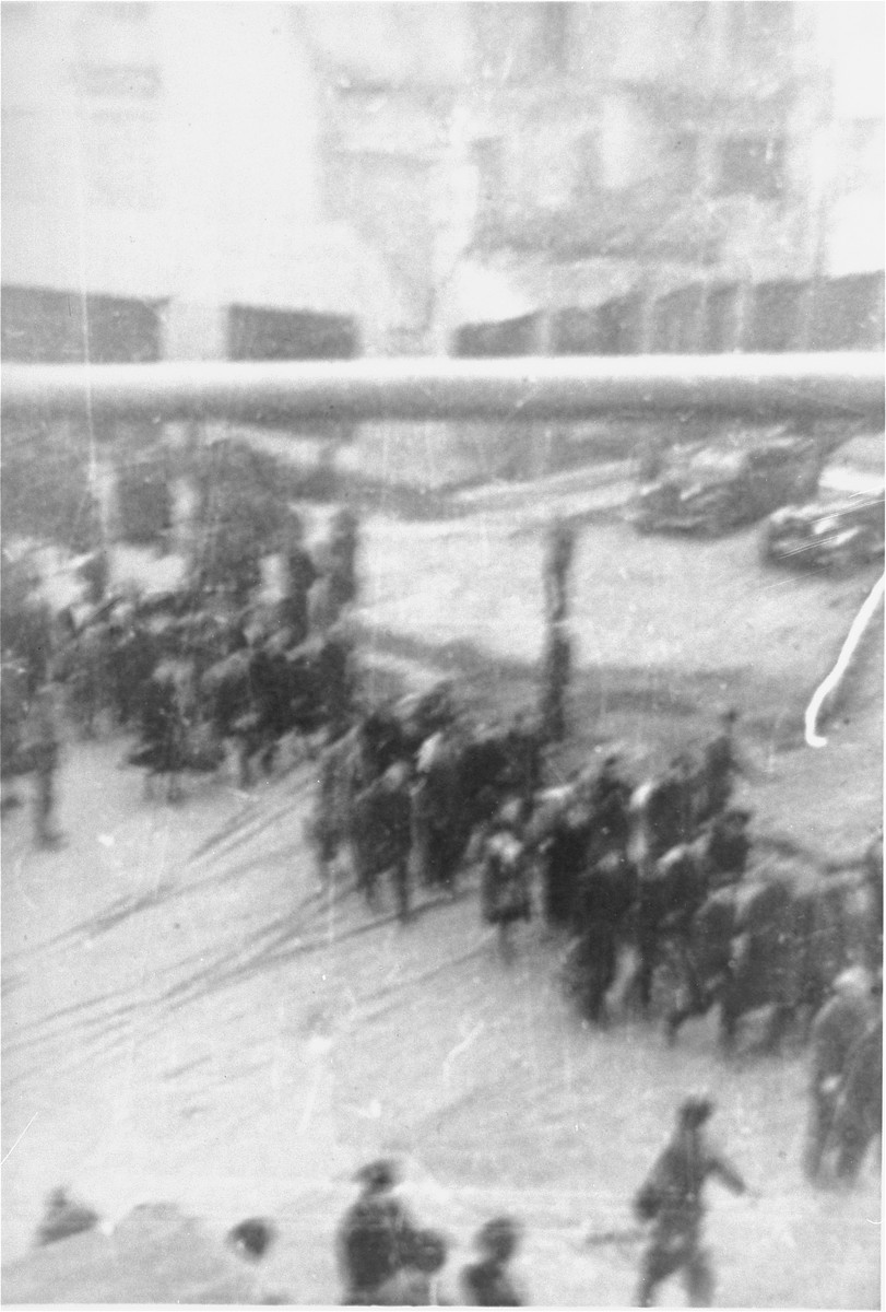 Jews captured by the SS during the suppression of the Warsaw ghetto uprising march to the Umschlagplatz for deportation.